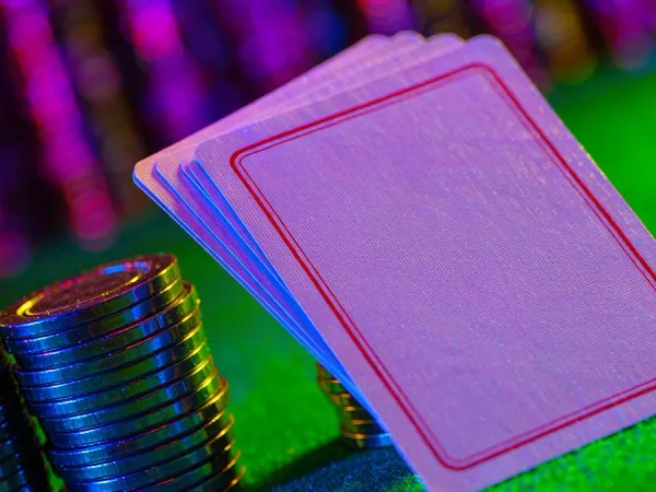 m666 Face-down playing cards beside colourful casino chips
